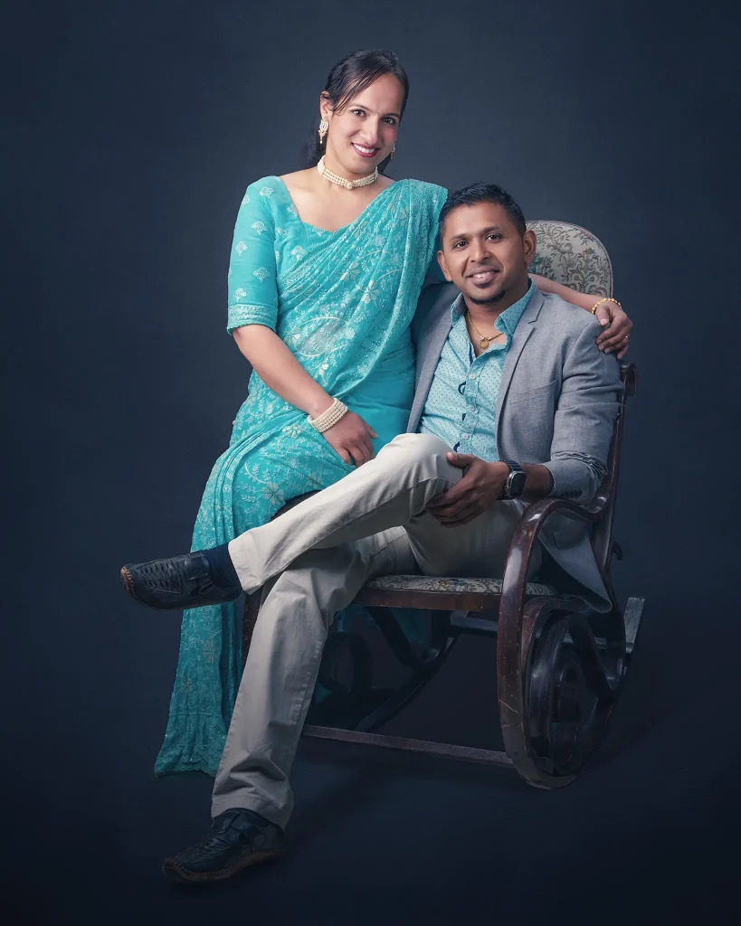 Couple portrait seated on a vintage chair in a Christchurch studio