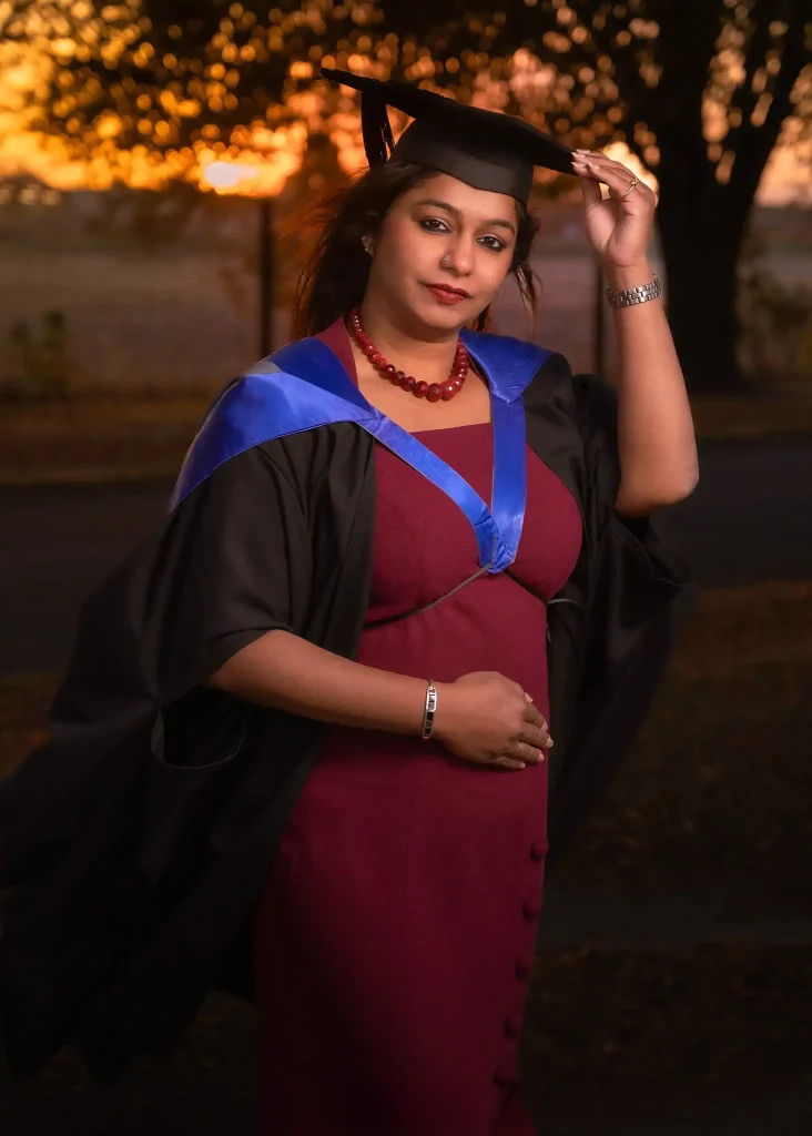 Woman in graduation gown at sunset in Christchurch