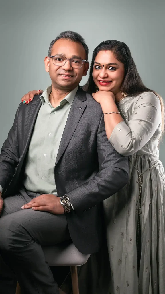 Smiling couple in formal attire posing together in a studio portrait in Christchurch