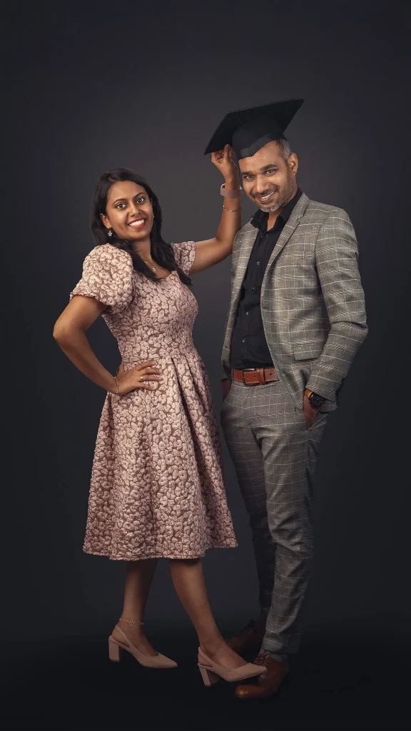 Studio portrait of a smiling couple with graduation cap in Christchurch