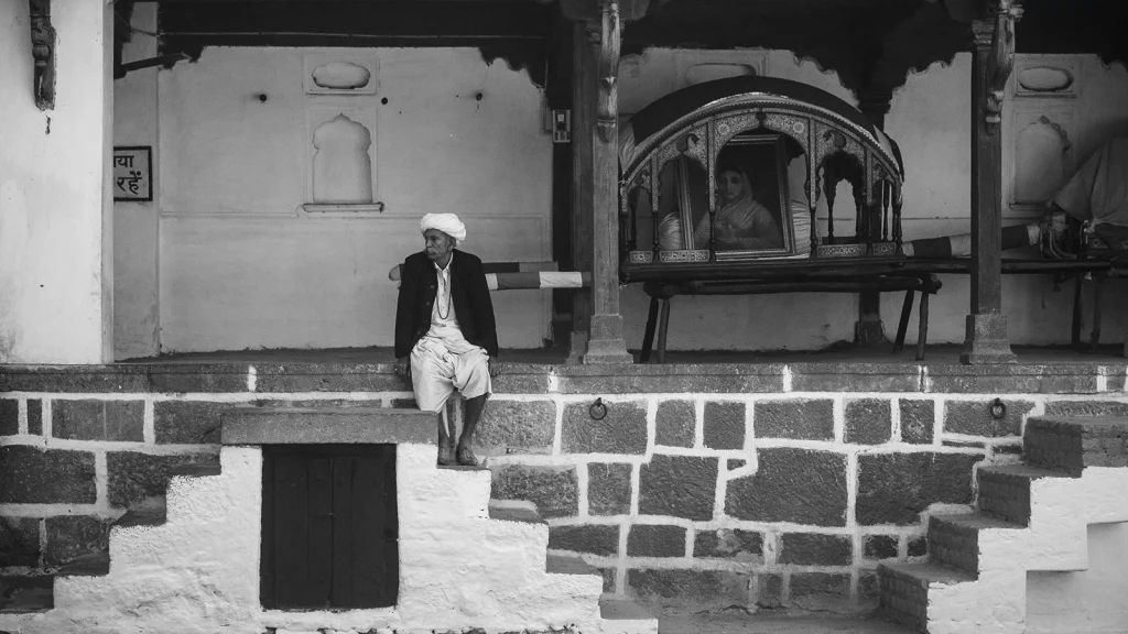 Elderly man sitting at Holkar Palace in Indore, India
